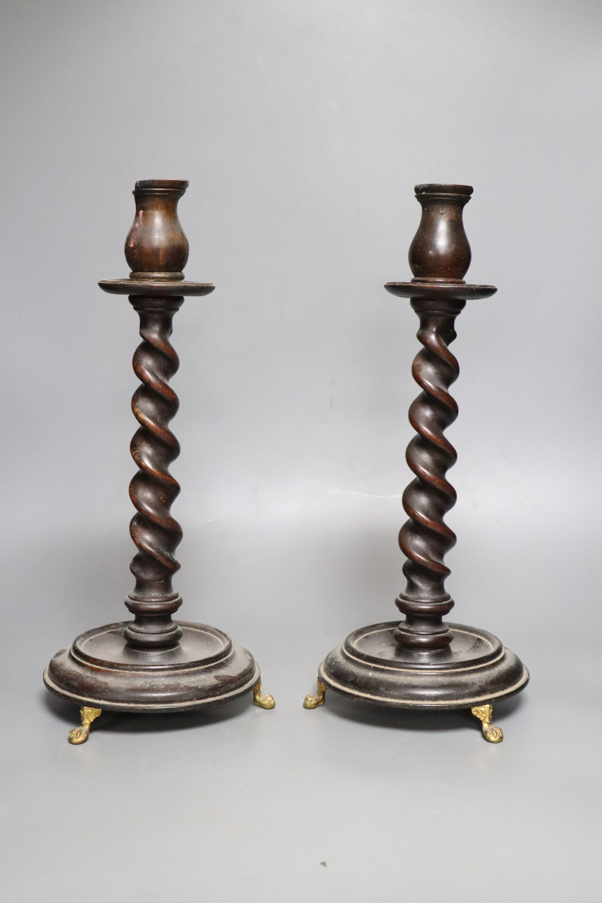 A pair of carved wood twist stem candlesticks, on gilt metal feet, height 39cm